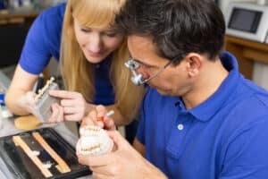 Dental technicians working on creating custom tooth restorations for a patient